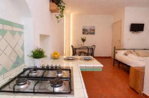 a kitchen with a stove top oven in a room at Il Portale 2 in Tropea