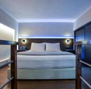 a bedroom with a large white bed in a room at The Lynx Konitsa in Konitsa