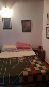 a bed in a bedroom with a patterned blanket on it at Casamira in Rosario