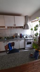 a kitchen with white cabinets and a stove at Casamira in Rosario
