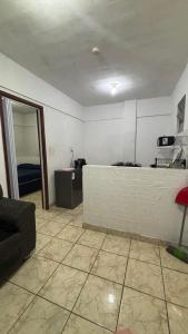 a living room with a couch and a table at Ótimo Quarto e Sala mobiliado em itapoa. in Vila Velha
