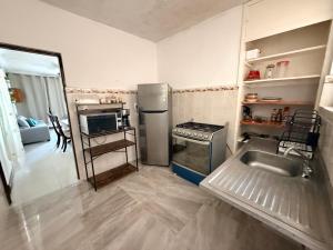 a kitchen with a stainless steel refrigerator and a sink at Departamento completo bien ubicado in Minatitlán