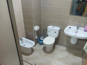 a bathroom with a toilet and a sink at تجزئة الفتح 925 خريبكة 4 in Khouribga