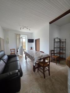 a living room with a table and a couch at Gîte Le Campagnard in Saint-Germain-des-Bois