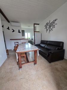 a living room with a table and a couch at Gîte Le Campagnard in Saint-Germain-des-Bois