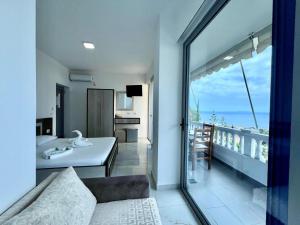 a living room with a view of the ocean from a balcony at Hotel Joni Lukove in Lukovë