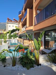 a building with a swimming pool and some plants at Lina Life in Fethiye