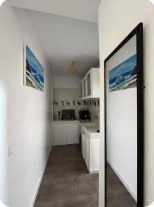 a kitchen with white cabinets and a large mirror at White House TAMRAGHT in Agadir