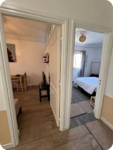 a hallway leading to a bedroom with a bed at White House TAMRAGHT in Agadir +3 photos