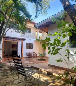 a chair in the courtyard of a house at Sunrise Guest House in León