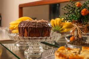 a chocolate cake sitting on a glass table at Pousada Drehmer Haus in Gramado
