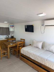 a room with a bed and a desk and a table with a tableablish at Cabañas boutique la soñada BIS in Fiambalá
