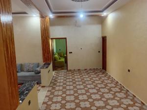 a living room with a couch and a table at شقة الياس in Agdz