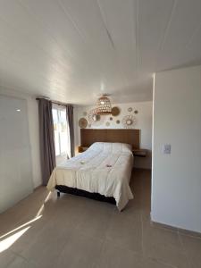 a bedroom with a bed and a large window at Cabañas boutique la soñada BIS in Fiambalá