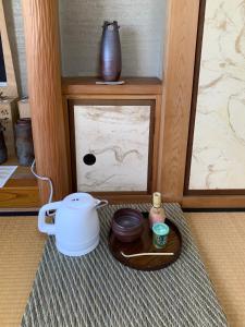 a table with a coffee maker and a pot on a tray at La Pace Awaji in Osaka