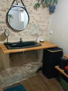 a bathroom with a black sink and a mirror at El Bosquet 1897 in Mogente +16 photos