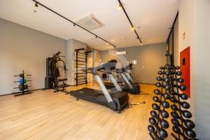 a gym with a treadmill and exercise equipment in a room at Moderno estudio c/ 1vaga in São Caetano do Sul
