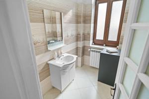 a bathroom with a sink and a mirror at Villa Boema- with parking for large business groups in Bucharest +32 photos