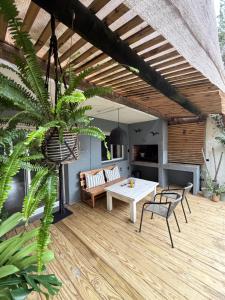 a patio with a table and chairs on a wooden deck at Puerta Azul in Punta del Este