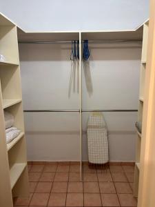 ein begehbarer Kleiderschrank mit weißen Wänden und weißen Schränken in der Unterkunft Depa B Bosques del Contry in Monterrey
