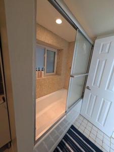 a bathroom with a shower with a glass door at Comfortable living, within reach! in Oak Park