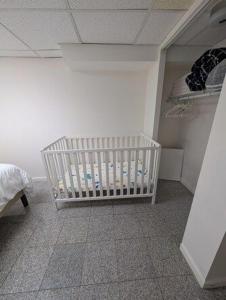 a nursery with a crib in a room at Comfortable living, within reach! in Oak Park +14 photos