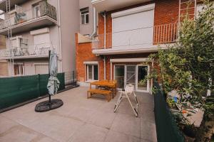 a patio with an umbrella and a table and a chair at Cozy vibes deluxe in Antwerp