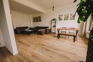 a living room with a couch and a table at Cozy vibes deluxe in Antwerp