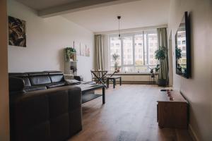 a living room with a couch and a table at Cozy vibes deluxe in Antwerp