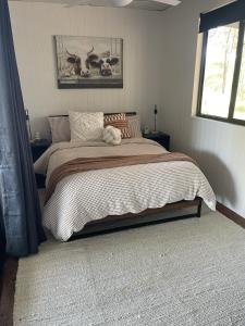 a bedroom with a large bed in a room at Hayden's Place in Wamuran