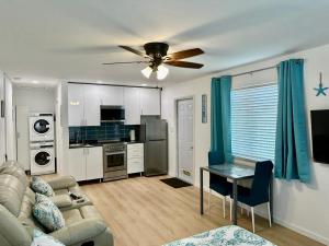 a living room with a couch and a ceiling fan at Seashell 8 - Seasonal Rental in Boynton Beach