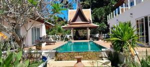 a swimming pool with a gazebo next to a house at Villa Ban Tai Zero, Master Bedroom Bungalow in Nathon Bay