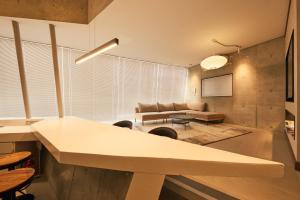 a living room with a table and a couch at Crane Stay Shibuya in Tokyo