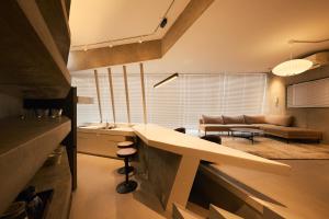 a kitchen and living room with a table and a couch at Crane Stay Shibuya in Tokyo