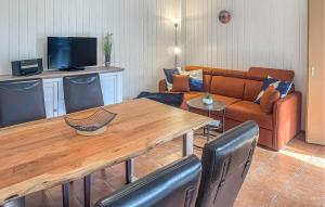 a living room with a wooden table and a couch at Fh Blau in Warenthin