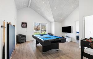 a room with a pool table and a tv at Stunning Home In Hasle With Sauna in Hasle +15 photos