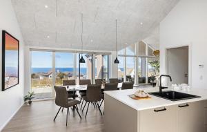 a kitchen and dining room with a table and chairs at Stunning Home In Hasle With Sauna in Hasle