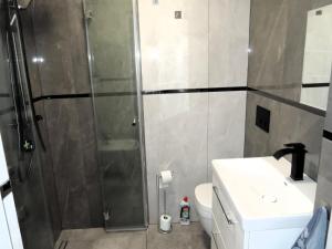 a bathroom with a shower and a toilet and a sink at New apartment in Wise ka in Wisełka +15 photos