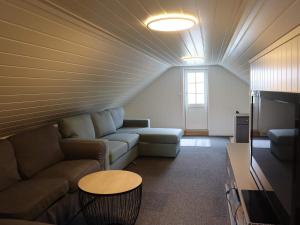 a living room with a couch and a table at 7 person holiday home in Risør in Risør