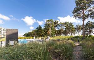 a pool in a park with tall grass at Baltic in Binz +35 photos