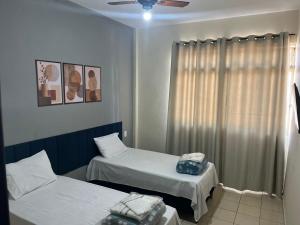 a hospital room with two beds and a window at Hotel San Remo in Ubá