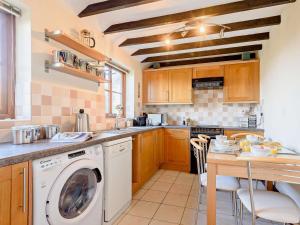 a kitchen with a washer and dryer at 2 Bed in Matlock oc-81116 in Crich