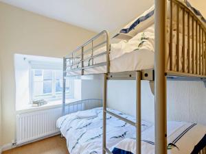 a bedroom with two bunk beds and a window at 2 Bed in Matlock oc-81116 in Crich