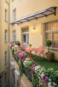 a balcony with a table and chairs and flowers at Budapest Cereja Boutique in Budapest