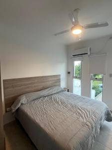a bedroom with a bed and a ceiling fan at Costumbres Argentinas Triples En suite in Avellaneda