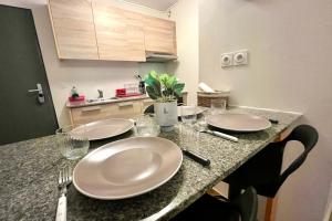 a kitchen with two white plates on a counter at FARE TEMEAO near ferry dock in Papeete