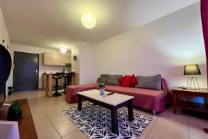 a living room with a couch and a table at FARE TEMEAO near ferry dock in Papeete
