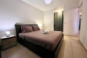 a bedroom with a bed with two towels on it at FARE TEMEAO near ferry dock in Papeete