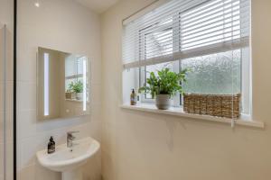 a bathroom with a sink and a mirror and a window at 2 Bed in Llangasty oc-d39006 in Llangorse +27 photos
