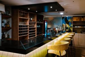 a bar with a row of stools in a restaurant at Ambar Hotel Boutique Cali in Cali